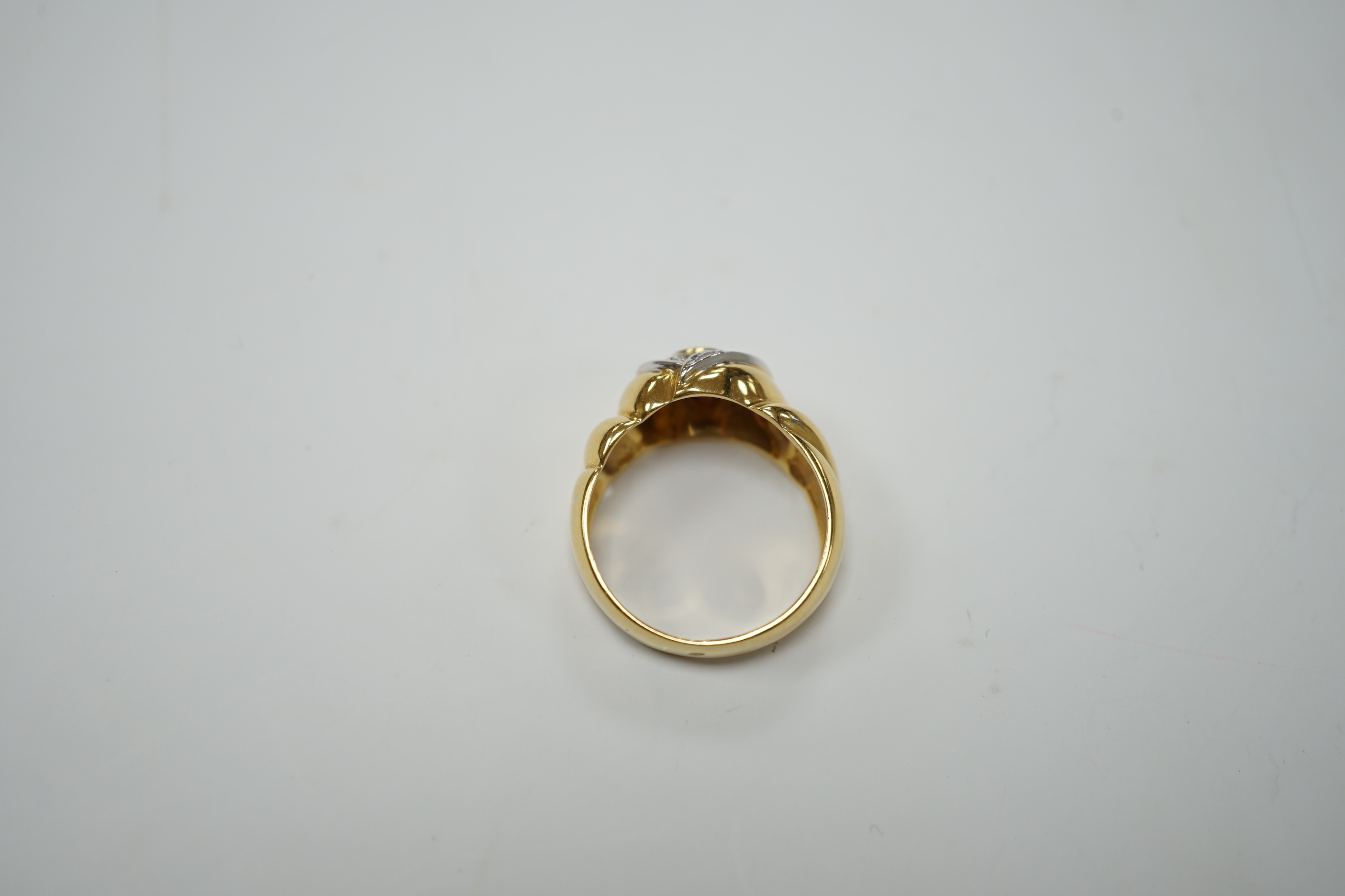 A modern 18ct gold, single stone deep pink sapphire and six stone diamond chip cluster set dress ring, size P, gross weight 8.3 grams.